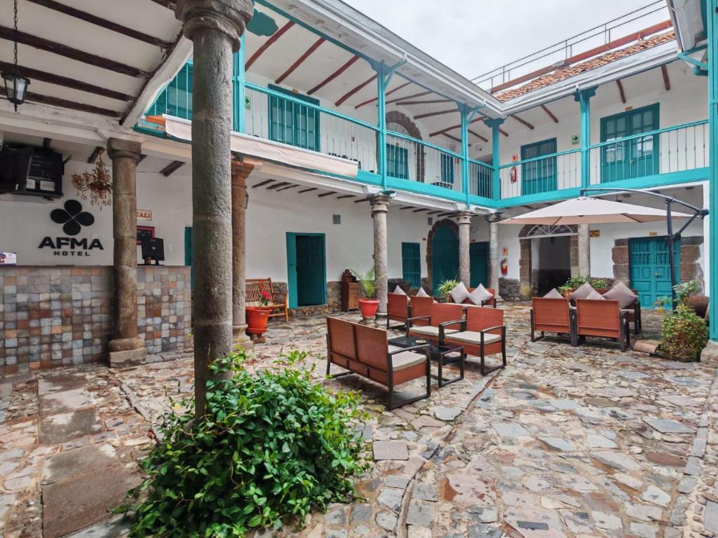 a patio with chairs and tables in a building at Afma Nueva Alta in Cusco
