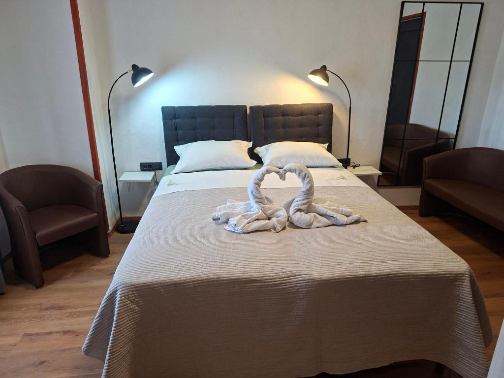 a bedroom with a bed with a towel on it at Apartments and Rooms "Almira" in Pula