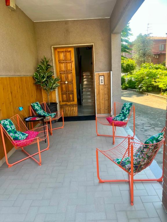 a group of chairs sitting on a porch at Motor Rooms in Maranello