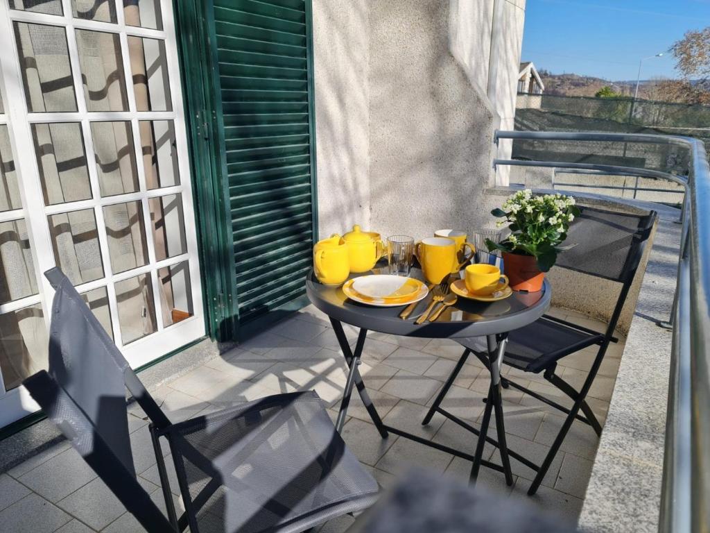 a table with a tray of food on a balcony at Garça-Real 1 in Vale de Madeiros