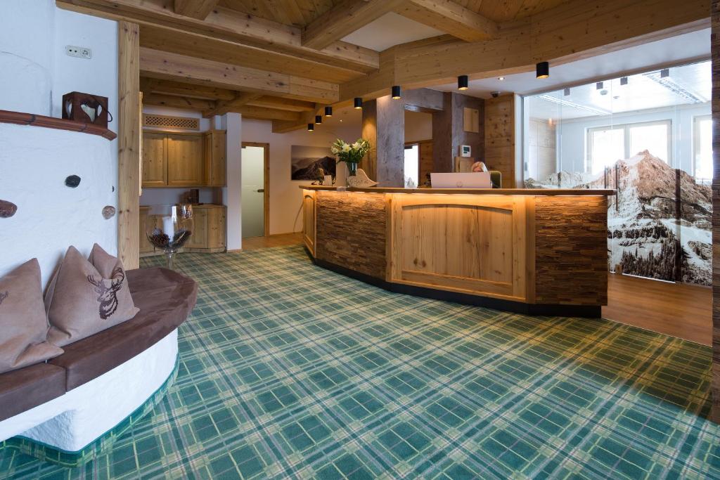a lobby with a reception desk in a building at Hotel Bergland in Pertisau