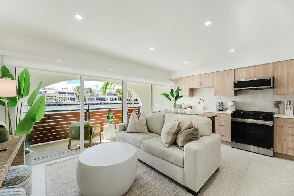 a living room with a couch and a kitchen at The Arches - Waterfront Suite in Boca in Boca Raton