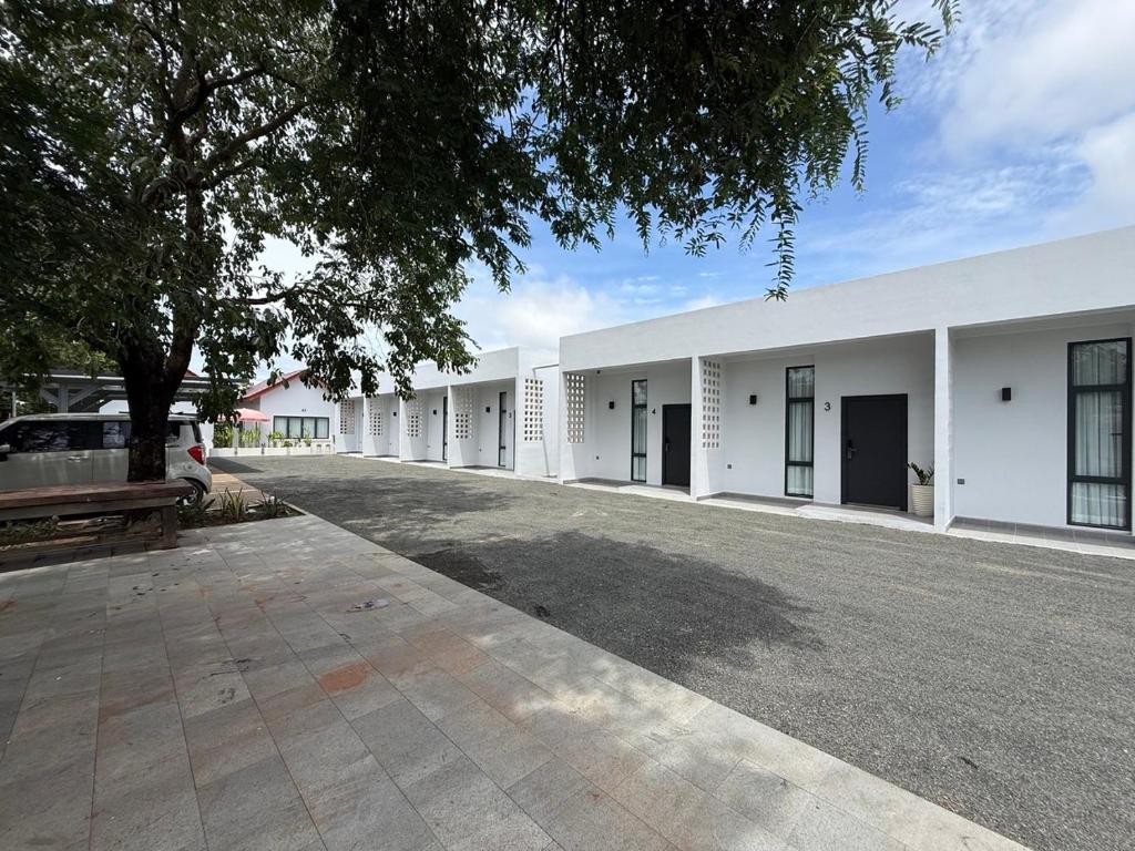 a row of white buildings with a parking lot at Family Motel in Bahal