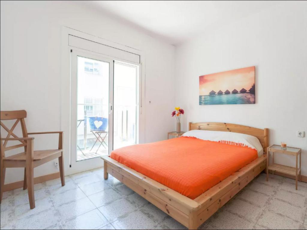 a bedroom with a bed and a large window at LG Plaza Merida Con Piscina in Blanes