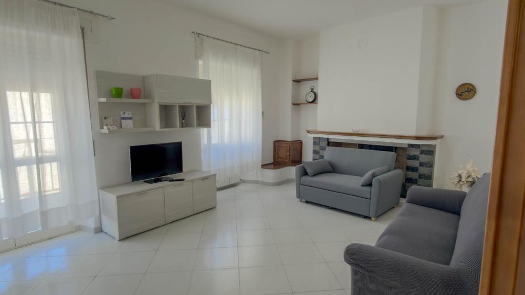 a living room with two chairs and a television at Casa Gala in Mamoiada
