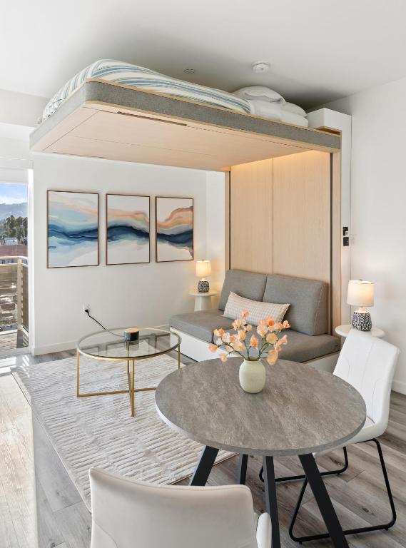 a living room with a couch and a table at Modern Hollywood Studio, Pool Parking Gym in Los Angeles