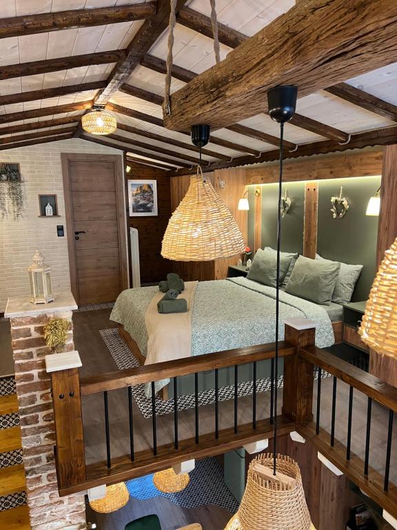 a bedroom with a bed in a room with beams at Scandinavian Rustic in Tríkala