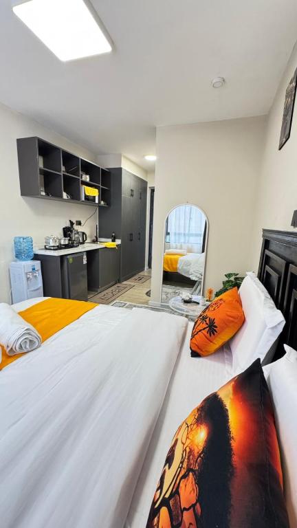 a large bedroom with two beds and a kitchen at Nene Homes in Marimbeti
