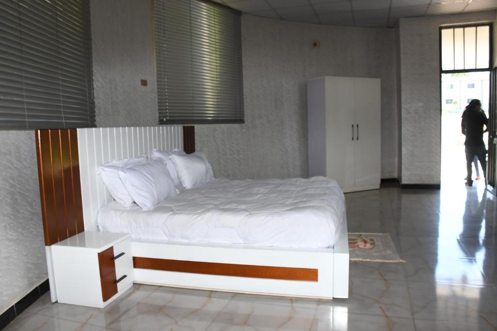 a bedroom with a white bed in a room at Royal Palace Hotel Harar in Hārer
