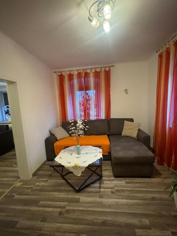 a living room with a couch and a table at Wohlfühlwohnung Wiesenfeld in Wiesenfeld