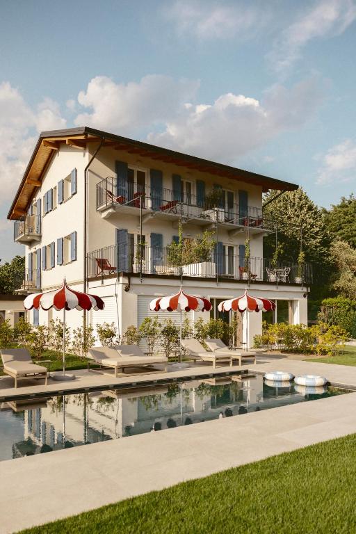 a hotel with a swimming pool in front of a building at Hortus Bellagio in Bellagio