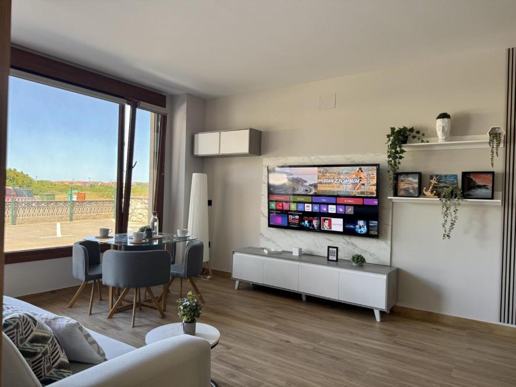 a living room with a table and a dining room at Flower Beach Helgueras 2 - 6092 in Noja