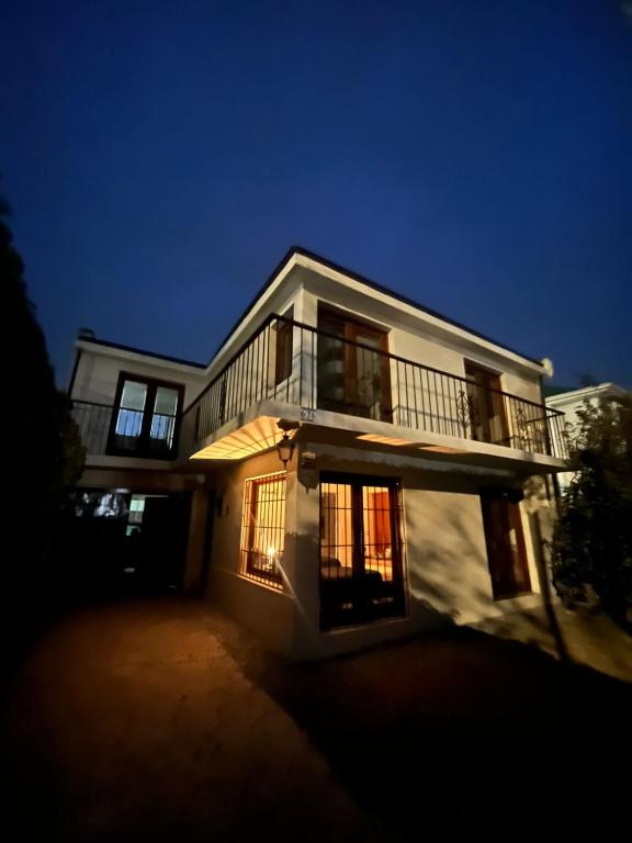 a large white house with a balcony on it at Global residencial in Rancagua