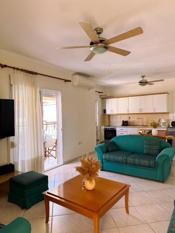 a living room with a blue couch and a table at Elizabeth's Home in Flogita