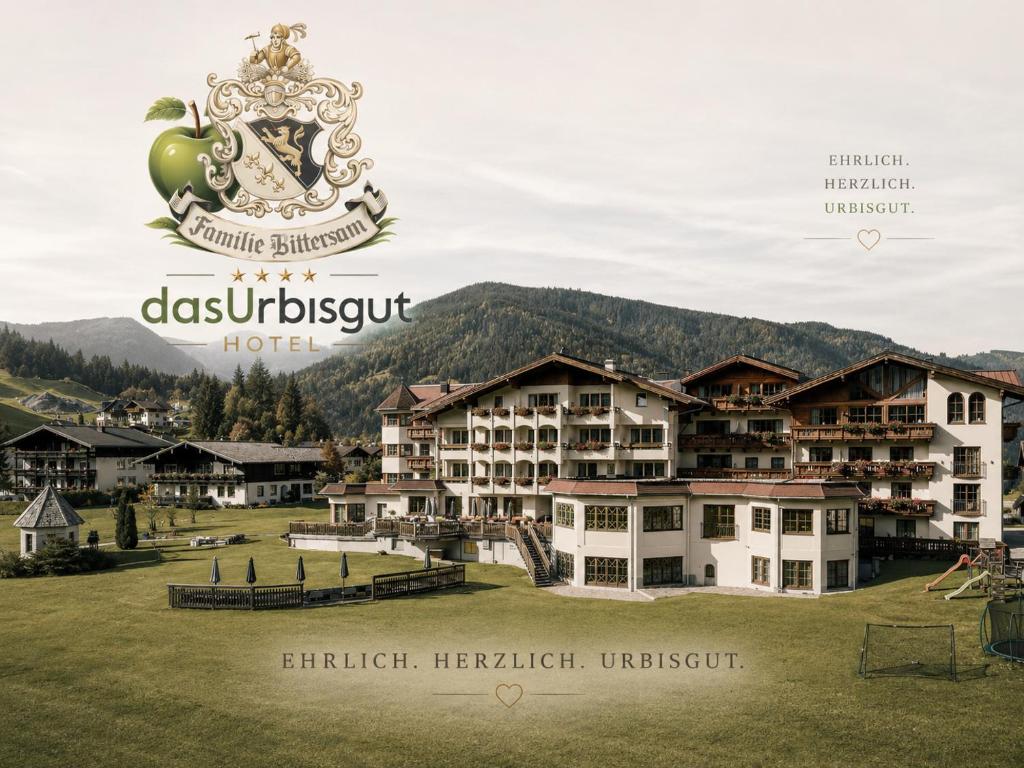 a sign for a hotel in front of a resort at Hotel Das Urbisgut in Altenmarkt im Pongau