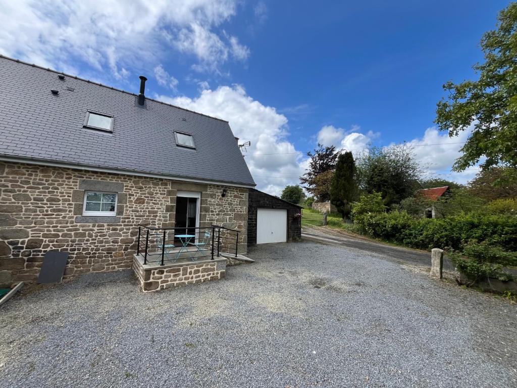 a brick house with a driveway in front of it at Maison campagne in Champ-du-Boult