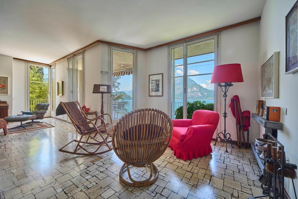 a living room with a red couch and chairs at Villa Lucy - Lake view in Varenna