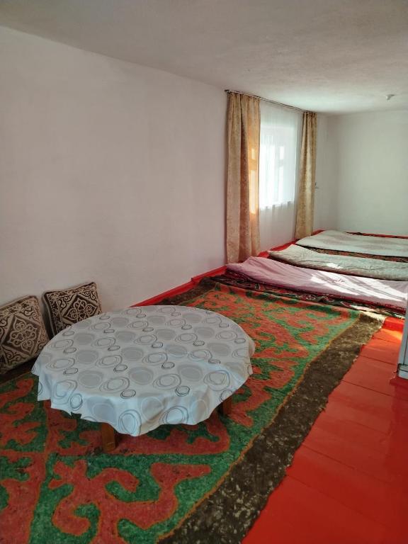 a room with a table and a bed in it at Chyrak home in Ak-Osten