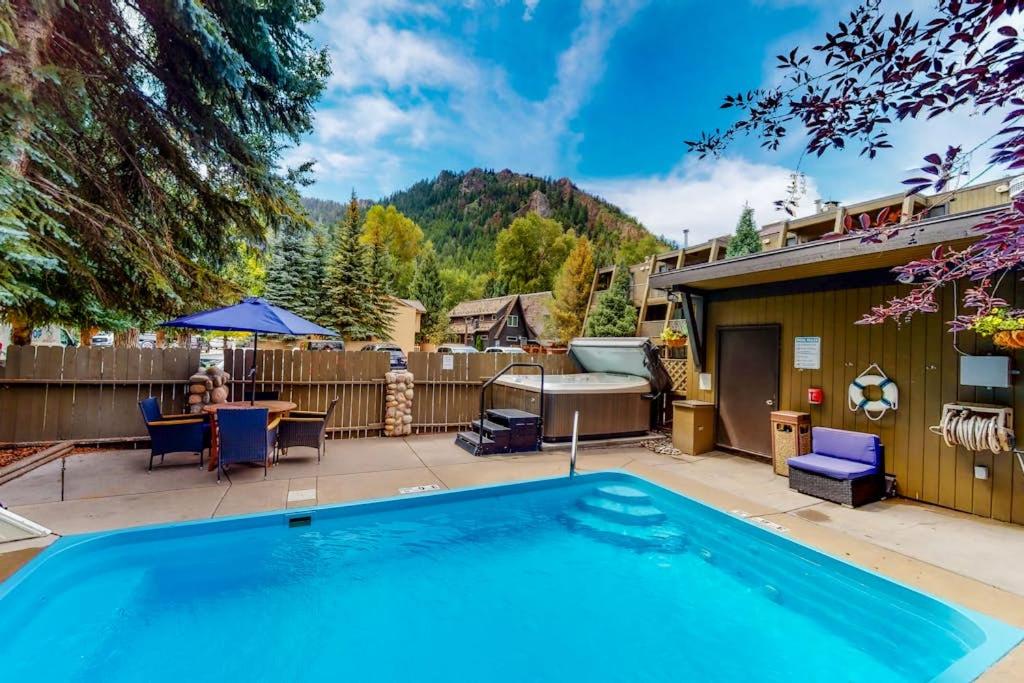 a swimming pool in the backyard of a house at Aspen Mountain Lodge in Aspen