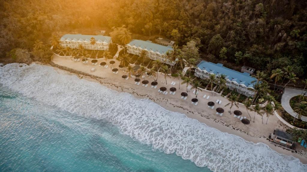 an aerial view of a resort on the beach at Soho Beach House Canouan in Canouan