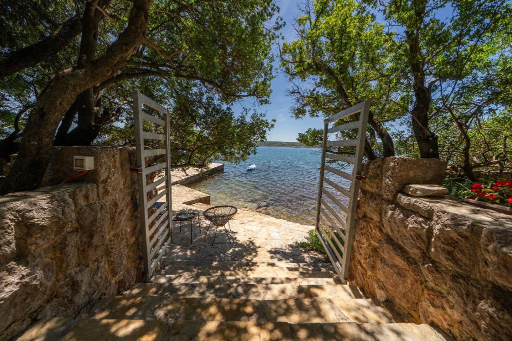 an open gate leading to a body of water at Holiday Home Baricevic in Posedarje