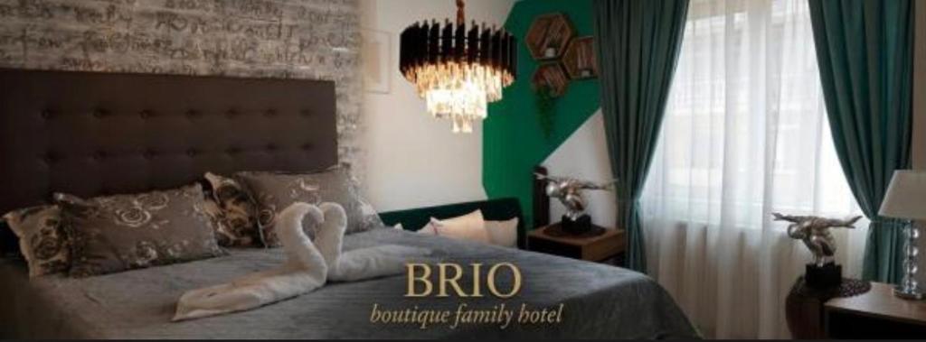 a bedroom with a bed with a swan made out of towels at Хотел Брио Велинград in Velingrad