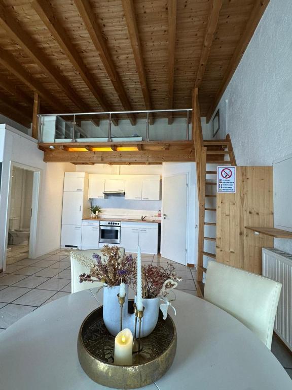 a kitchen with a table with a vase on it at Ferienwohnung Loft ca. 45 qm in Anröchte