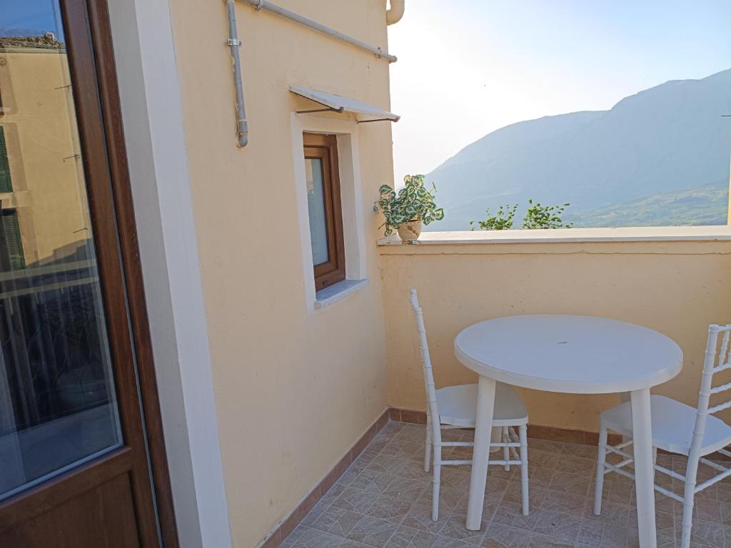a table and chairs on a balcony with a window at Affittacamere La Casa Dei Nonni in Polizzi Generosa