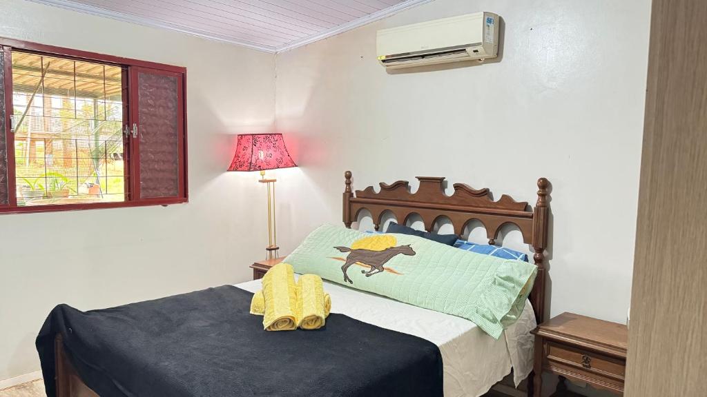 a bedroom with a bed with a monkey on it at Haras Cristal Experience in Gama