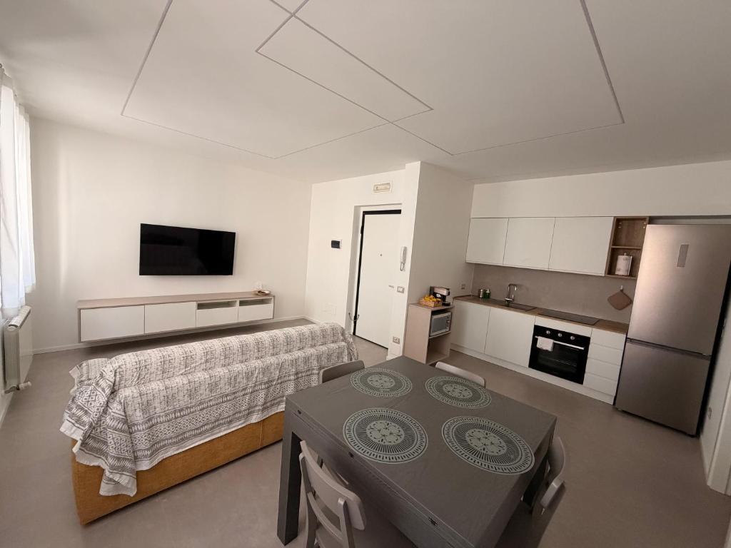 a bedroom with a bed and a table and a kitchen at Da Nella 1 in Ancona