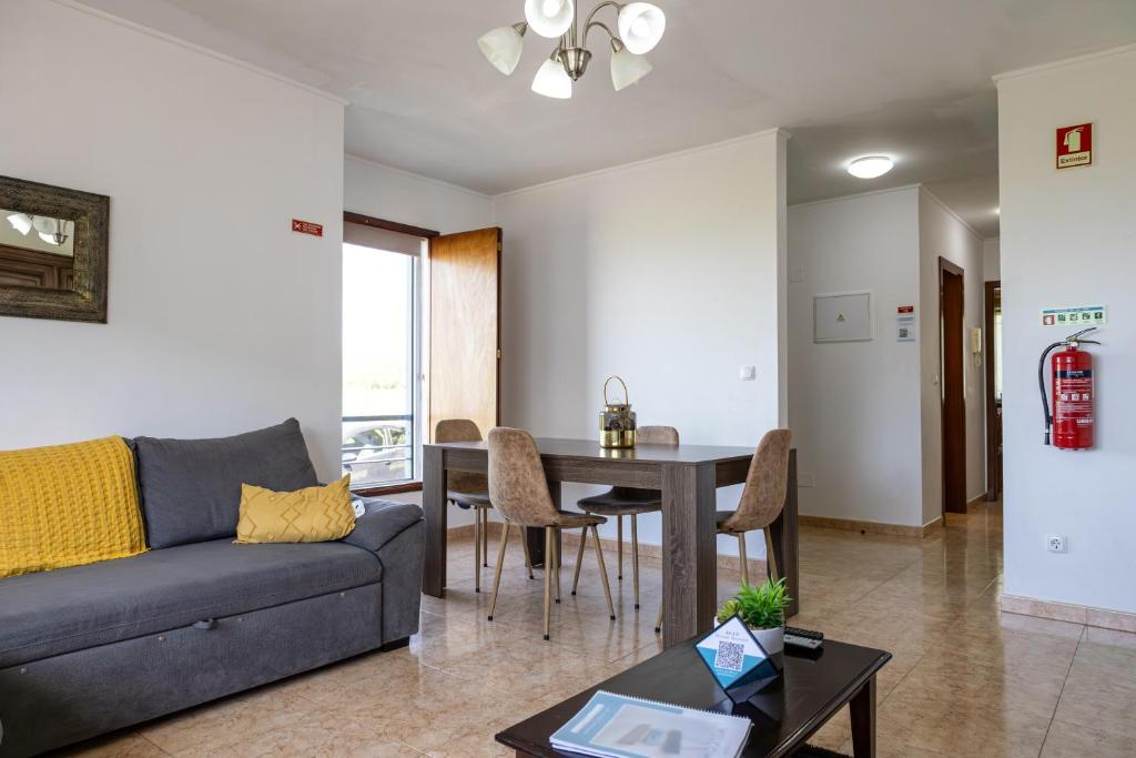 a living room with a couch and a table at Luz's Retreat Apartment in Ponta Delgada