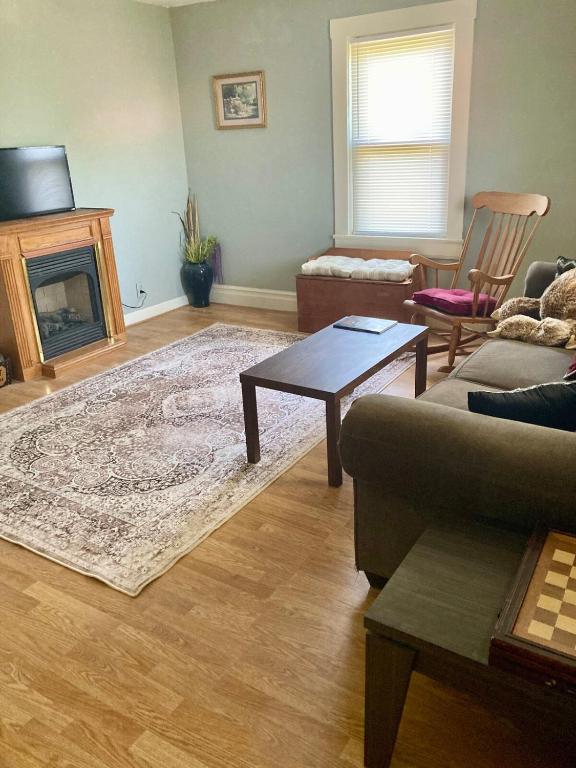 a living room with a couch and a fireplace at The Humble House in Martinsville