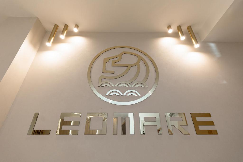 a sign on a wall with lights on it at Leomare in Odesa