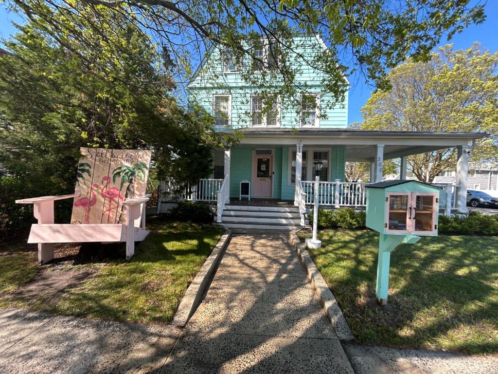 a house with two benches in front of it at Saltwater Inn in Belmar