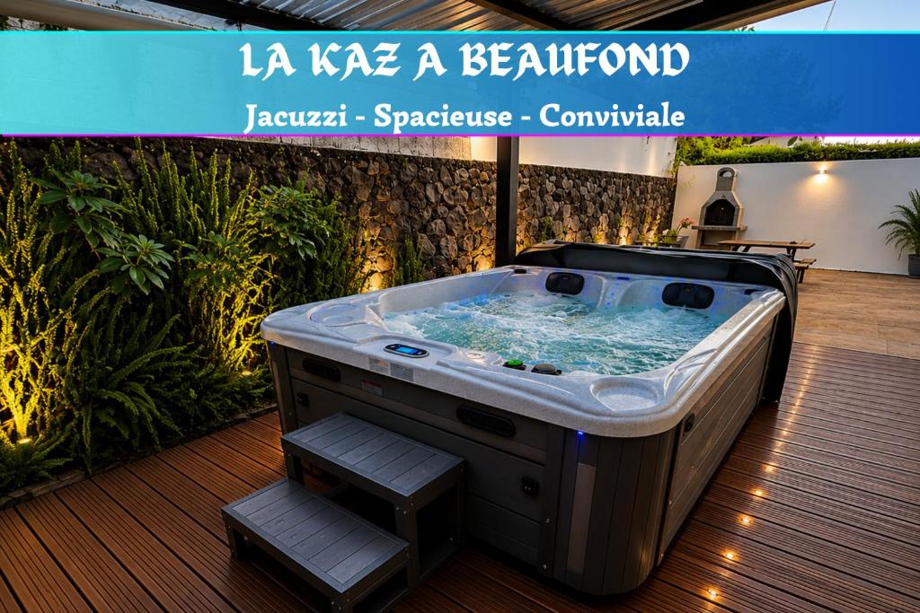 a jacuzzi tub in a room with plants at La Kaz Beaufond - Jacuzzi - T4 climatisée & familiale in Saint-Benoît