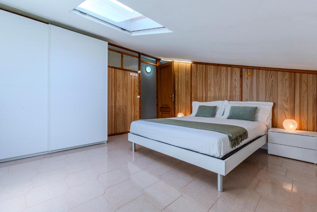 a bedroom with a large bed and wooden walls at Family friendly apartment in Giba Center in Giba