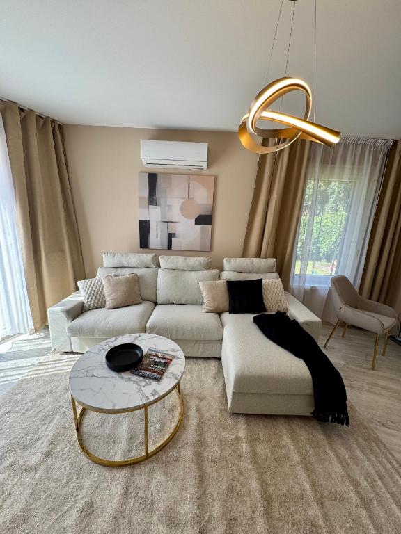 a living room with a couch and a table at Ditta Home in Nyíregyháza