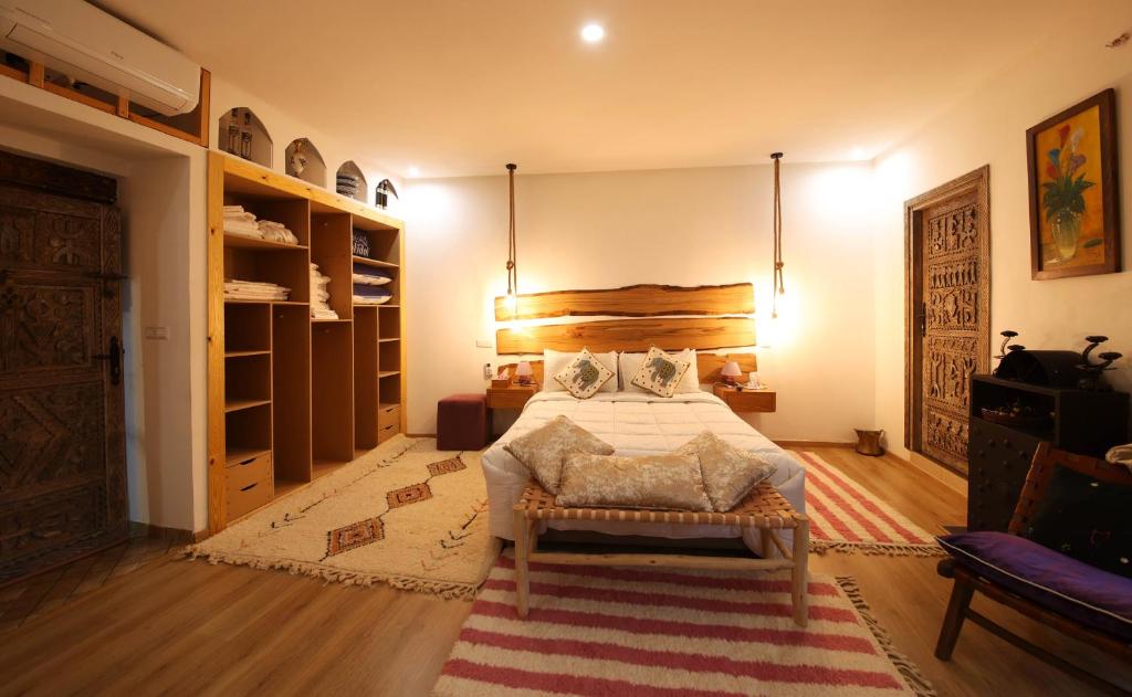 a bedroom with a large bed and a rug at laurier Rose Hostel in Ourika