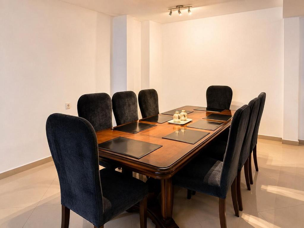 a dining room table with black chairs around it at Casa Di Manuelito in Monterrey