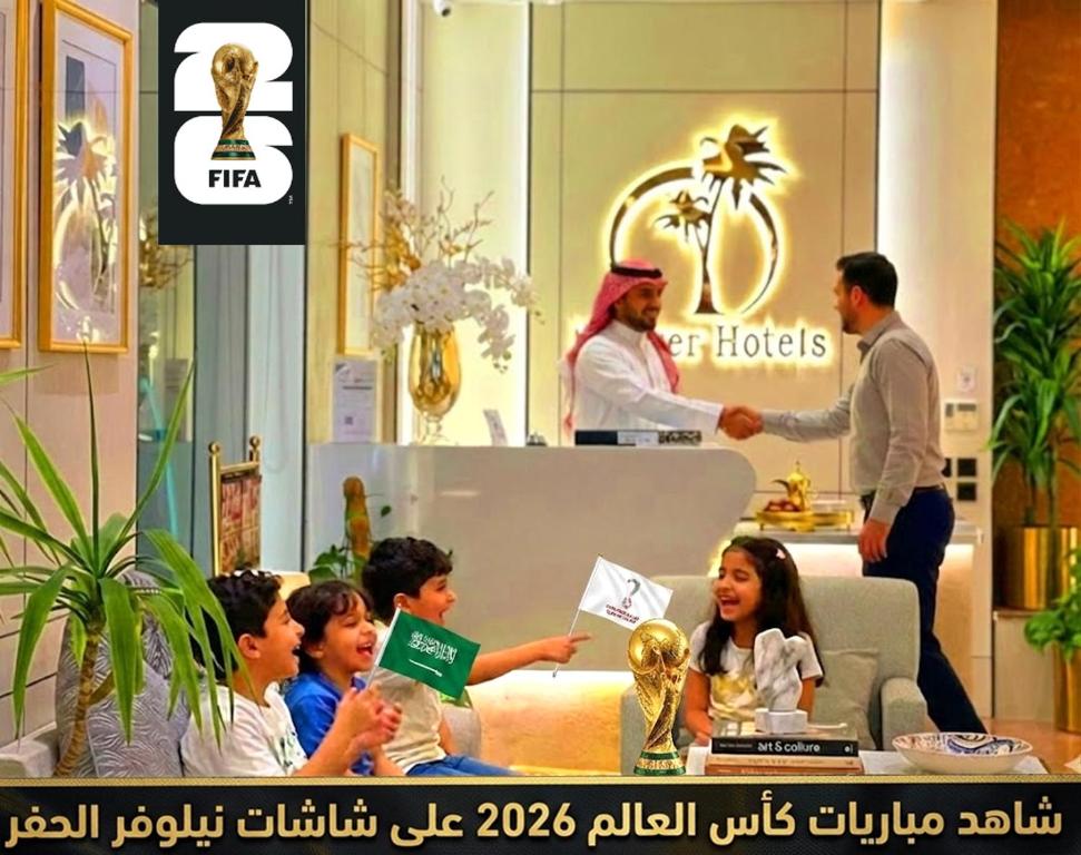 a group of children sitting in a room with a store at Nelover Hafar-Serviced apartments نيلوفر in Hafr Al-Batin