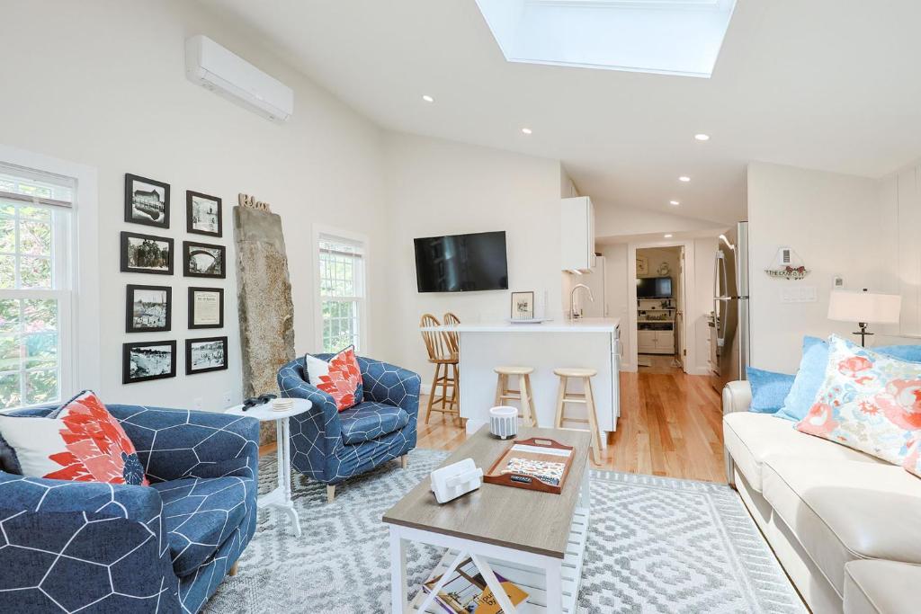 a living room with a couch and chairs and a table at Granite Cottage in Rockport