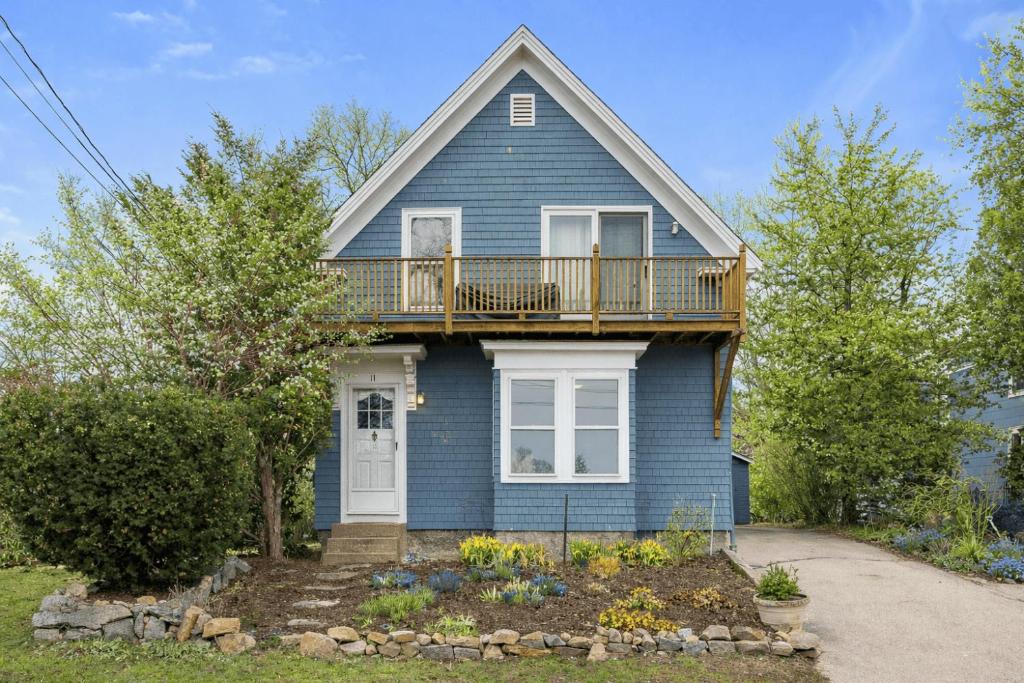 a blue house with a balcony on top of it at Helena House in Gloucester