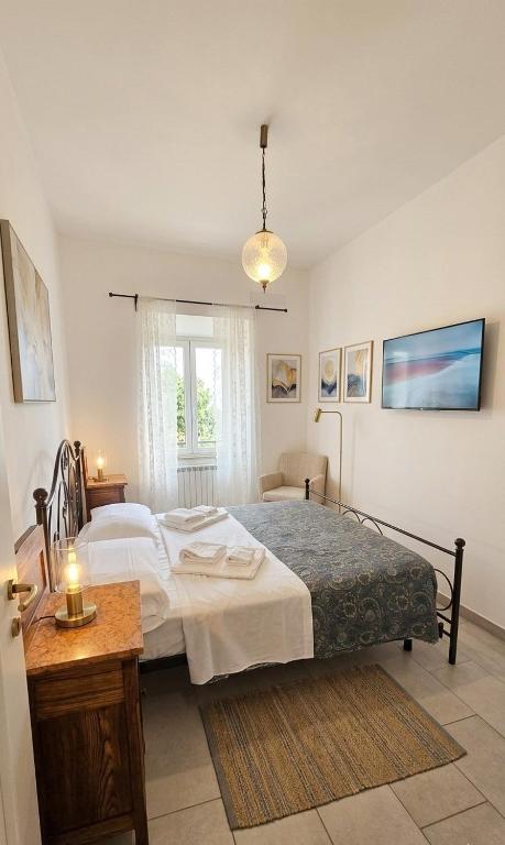 a bedroom with a large bed and a window at Da nonno Carlo Lakeview - By BorgoLago in Capodimonte