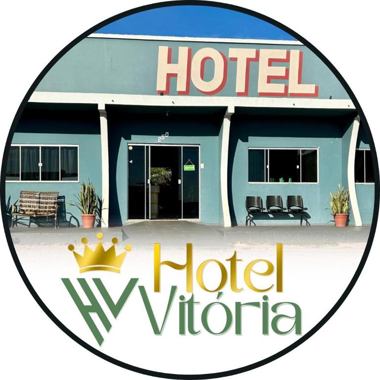 a sign for a hotel in front of a building at Hotel Vitoria in Matupá