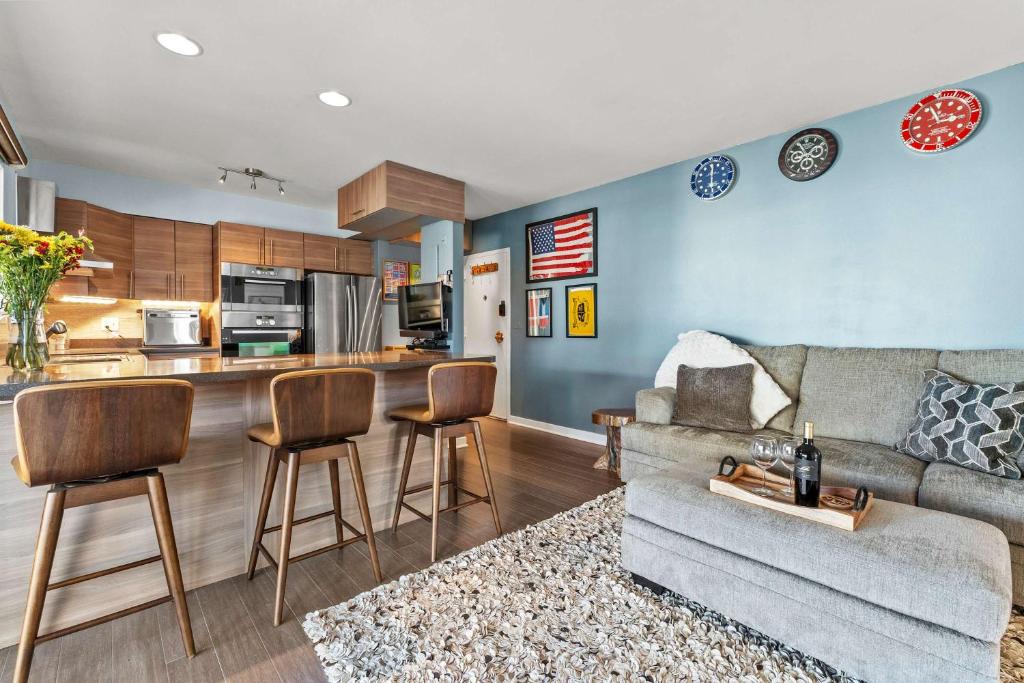a living room with a couch and a kitchen at Spa Creek Condo Pool Deck & Parking in Annapolis