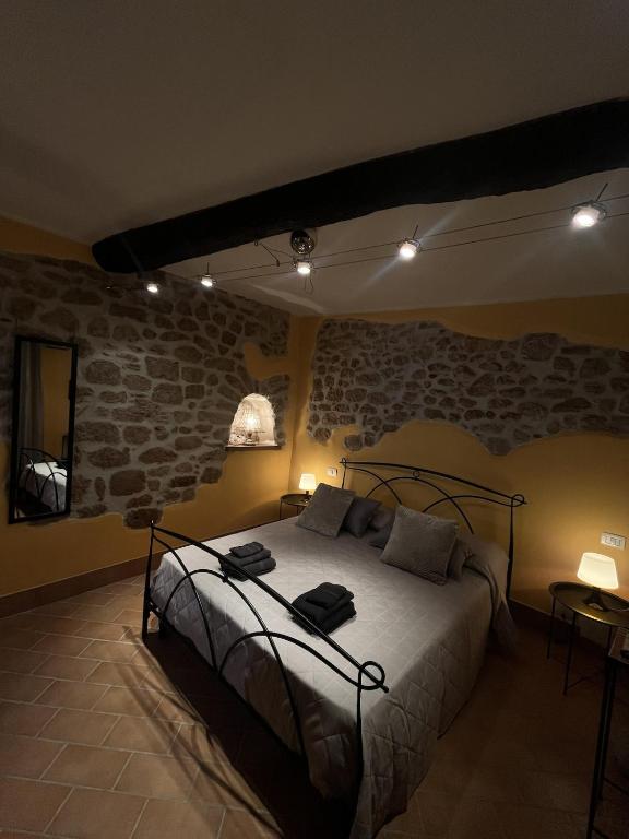 a bedroom with a bed and a brick wall at Casa Venusia in Alatri