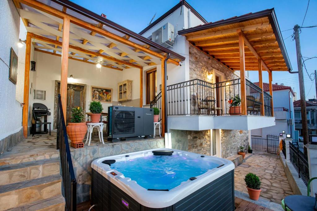 a hot tub on the patio of a house at Villa Arty in Limenaria