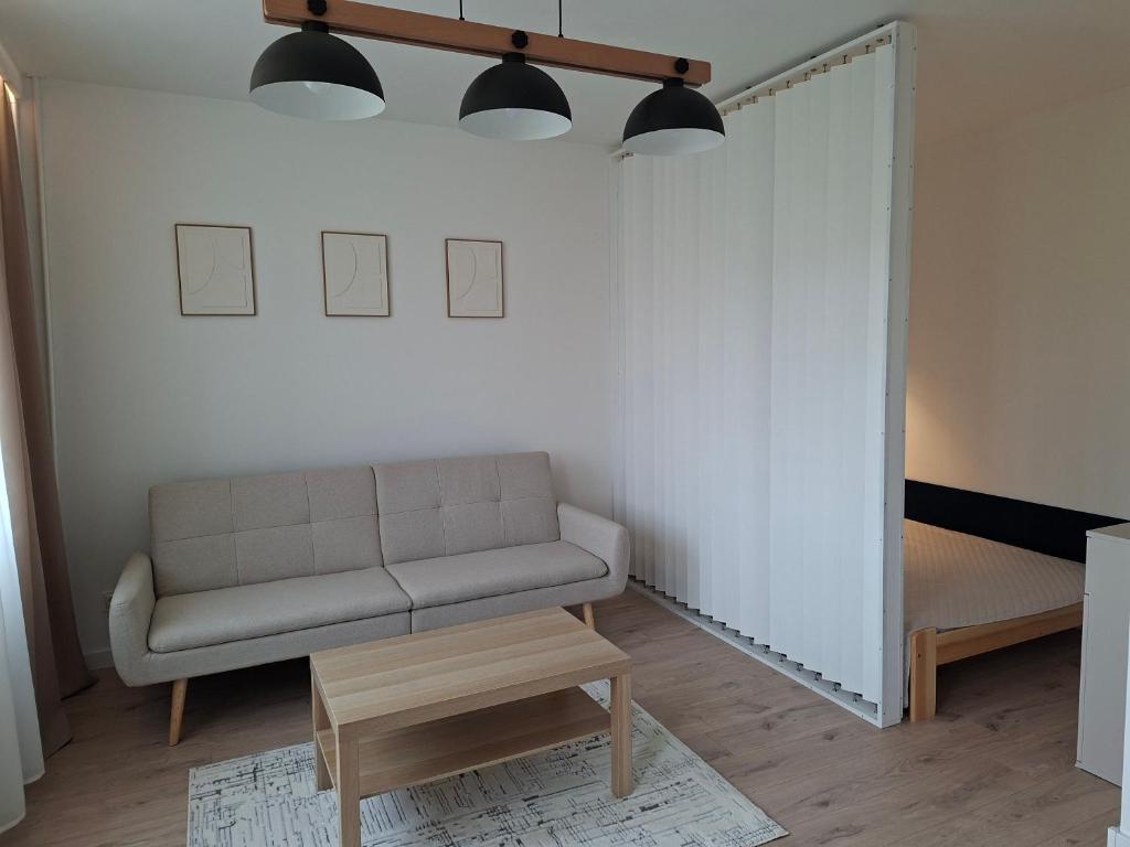 a living room with a couch and a table at Diwo Apartament in Koszalin