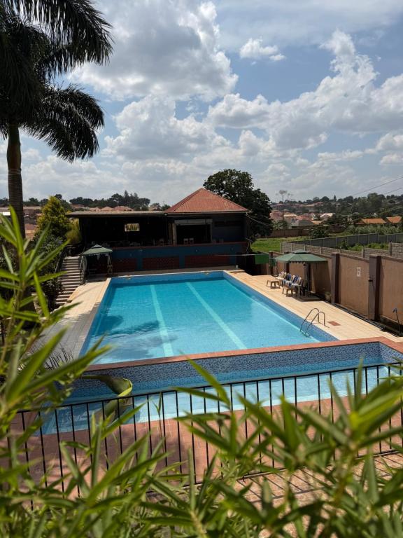 a large swimming pool in front of a building at Skylab Accomodationz in Kasangati