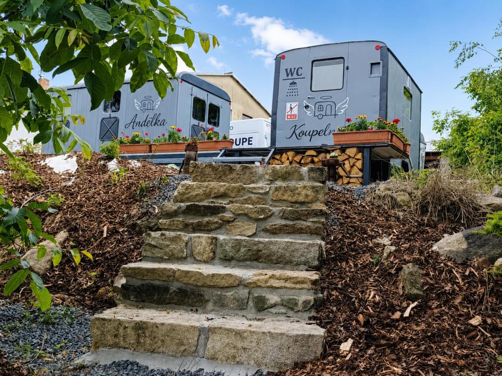 a stairway leading to an rv and a trailer at Andělka maringotka in Humpolec